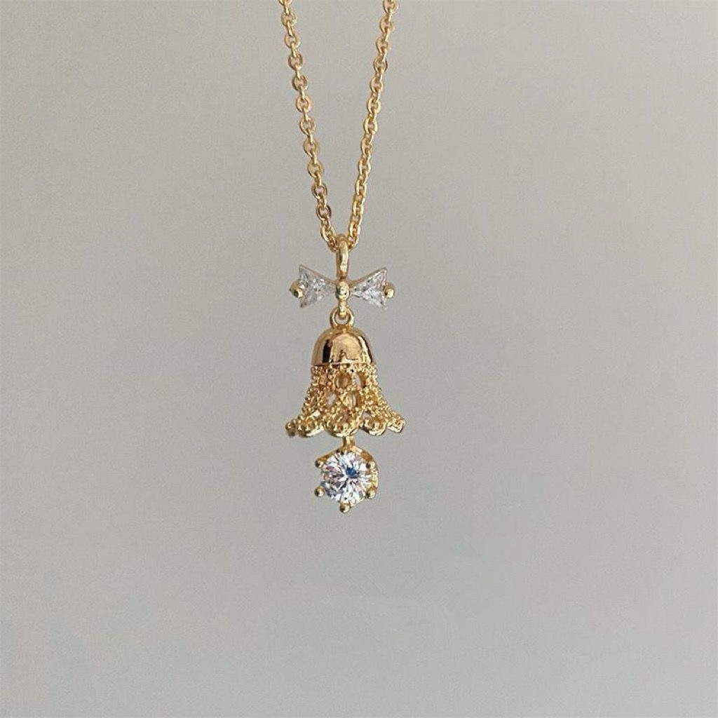 Gold Bell Necklace with Zircon Bow — Festive Pendant Jewelry